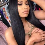 Nicki Minaj covers her huge cleavage with one arm as she goes topless in racy Easter selfies