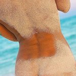 Back view of a naked woman on a sandy